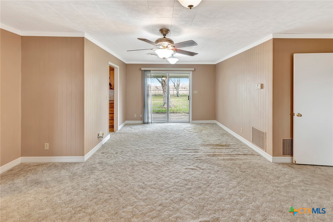 1840 Loop 522 Ganado, TX 77962 - Photo 20 of 48 a view of a livingroom with a window and a ceiling fan
