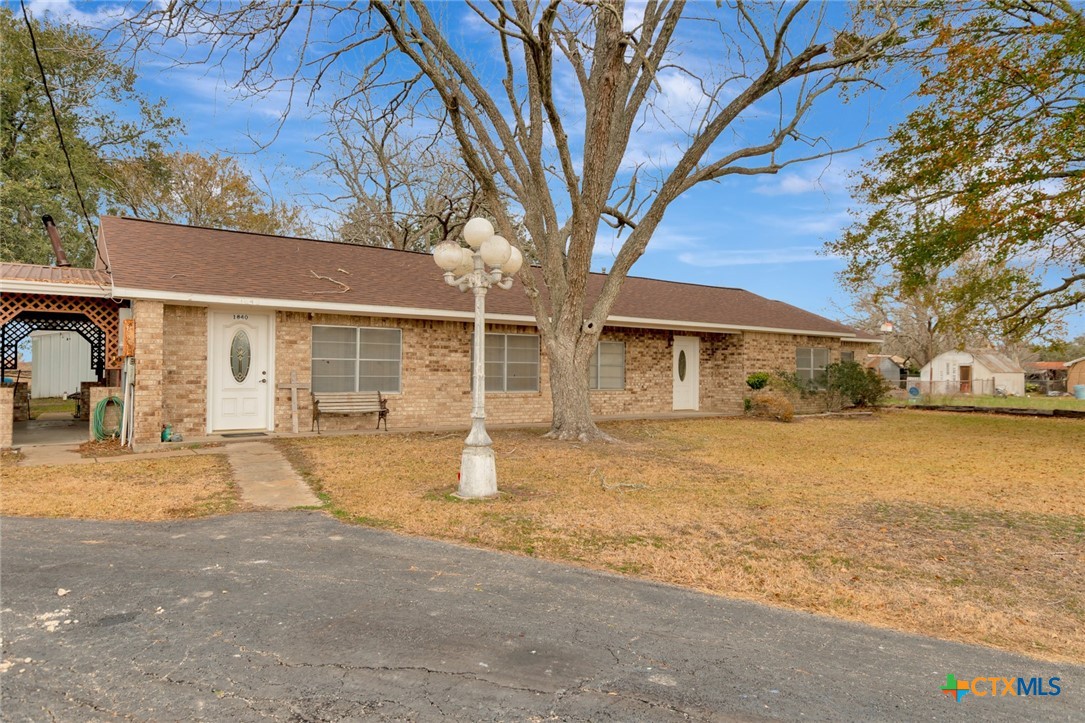 1840 Loop 522 Ganado, TX 77962 - Photo 2 of 48 a front view of a house with a yard and garage