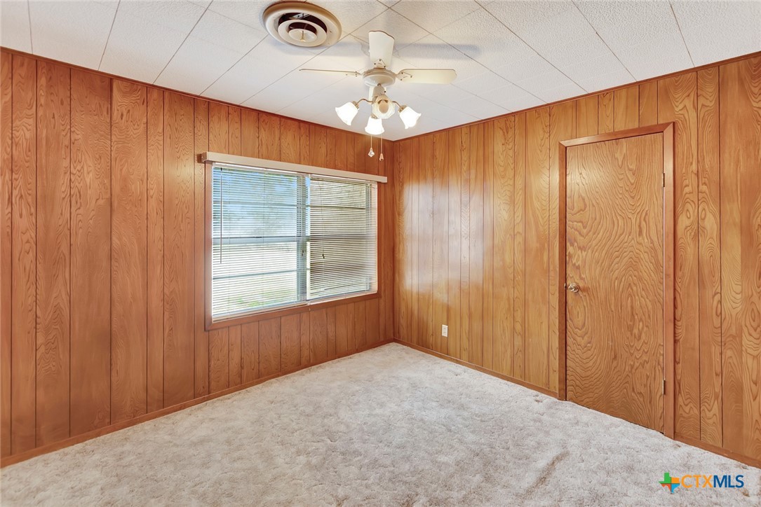 1840 Loop 522 Ganado, TX 77962 - Photo 31 of 48 an empty room with a chandelier fan and windows