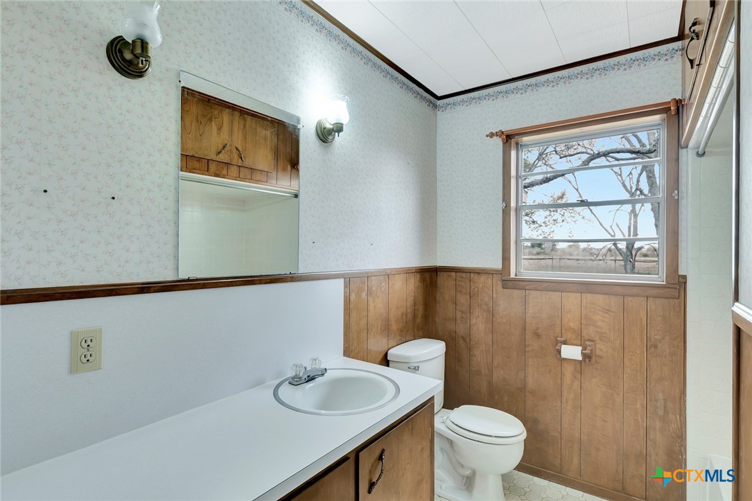 1840 Loop 522 Ganado, TX 77962 - Photo 33 of 48 a bathroom with a toilet a sink and a window
