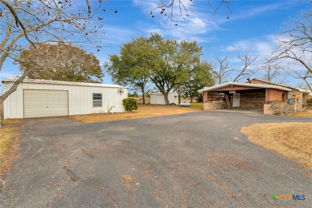 1840 Loop 522 Ganado, TX 77962 - Photo 6 of 48 a front view of a house with a yard and garage