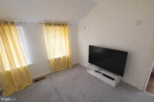 a living room with window and a flat screen tv