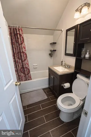 a bathroom with a toilet a sink and bathtub