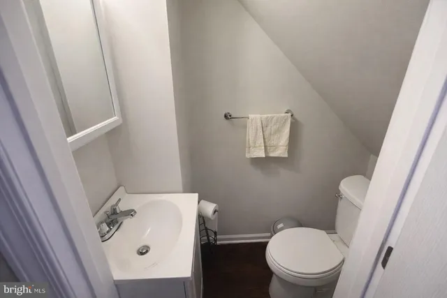 a white toilet sitting next to a white sink