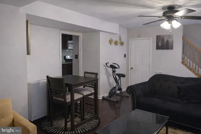 a living room with furniture a flat screen tv and a window