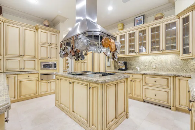 a kitchen with stainless steel appliances granite countertop a stove and white cabinets