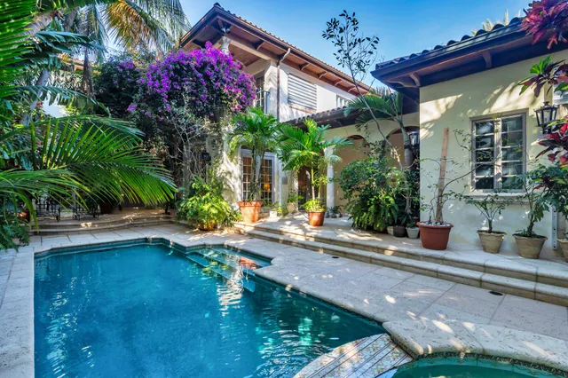 a view of a house with pool and sitting area