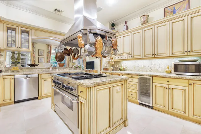 a kitchen with stainless steel appliances granite countertop a stove and a sink