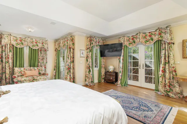 a spacious bedroom with a large bed and a large window