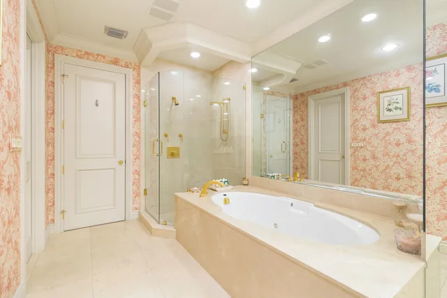 a spacious bathroom with a bathtub shower and a sink