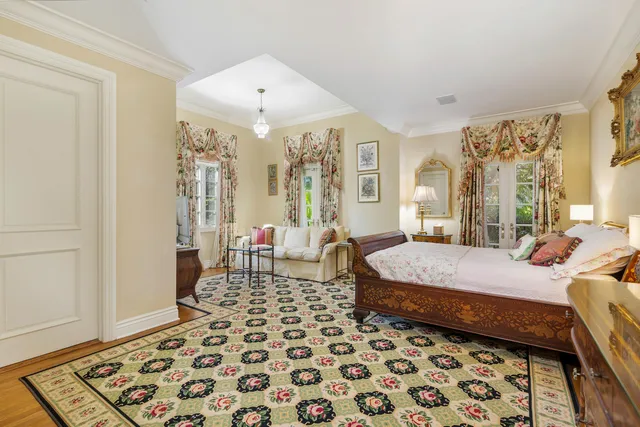 a spacious bedroom with a bed and a window