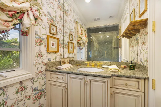 a bathroom with a granite countertop sink and a mirror