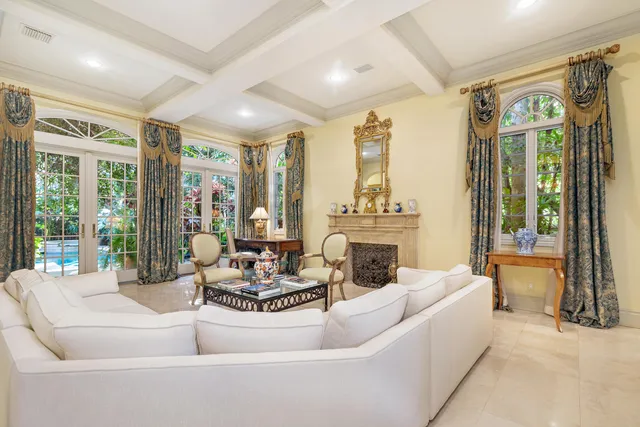 a living room with fireplace furniture and a large window