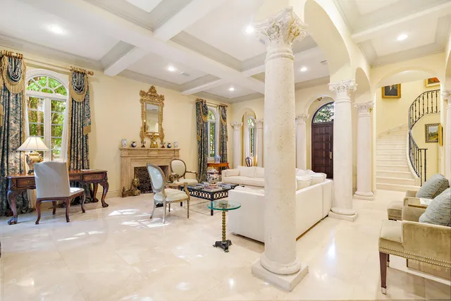 a living room with fireplace furniture and a large window