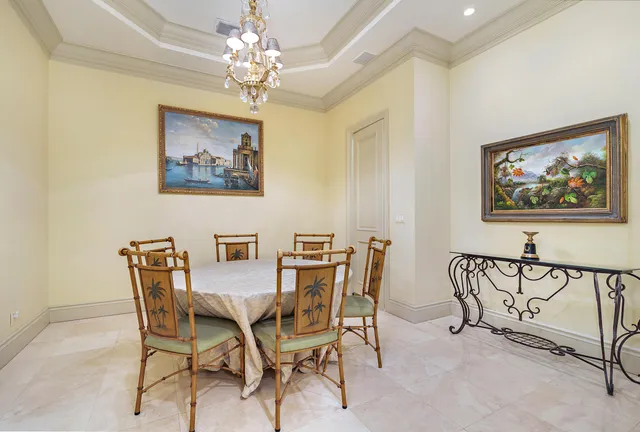 a view of a dining room with furniture and a chandelier
