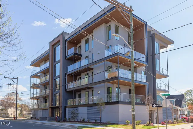 a kitchen with stainless steel appliances granite countertop a sink a stove a refrigerator and a wooden floor