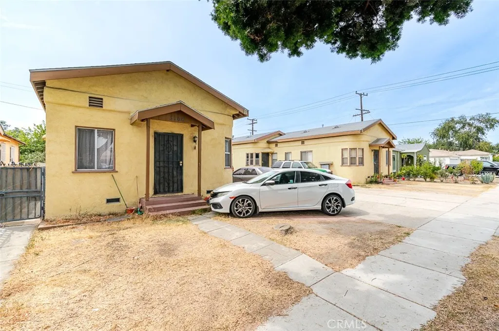 3164 Cherokee Avenue South Gate, CA 90280 - Photo 2 of 9 a view of a house with a large space and a car parked in front of it