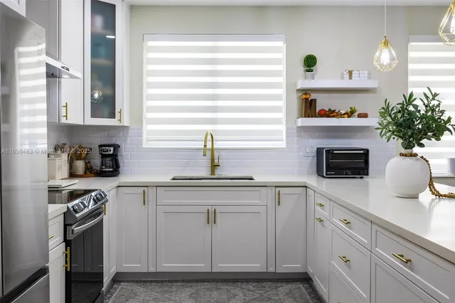 a kitchen with cabinets and appliances