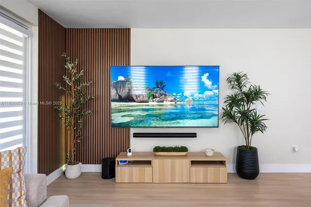 a view of a room with wooden floor and potted plant