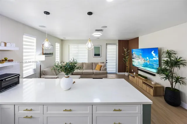 a view of living room with furniture and flat screen tv