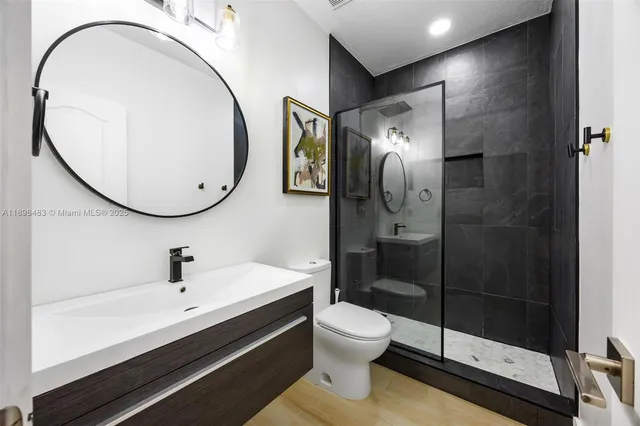 a bathroom with a sink a toilet and a mirror