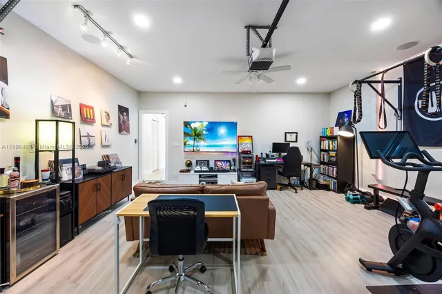 a view of a dining room with furniture a kitchen and chandelier