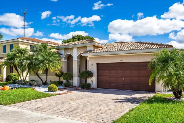 a front view of a house with a yard and garage
