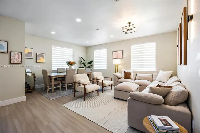 a living room with furniture wooden floor and a window
