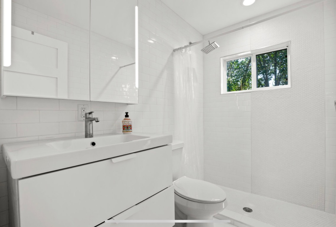 1305 Olander Street Austin, TX 78702 - Photo 13 of 14 a view of bathroom with a sink toilet and shower