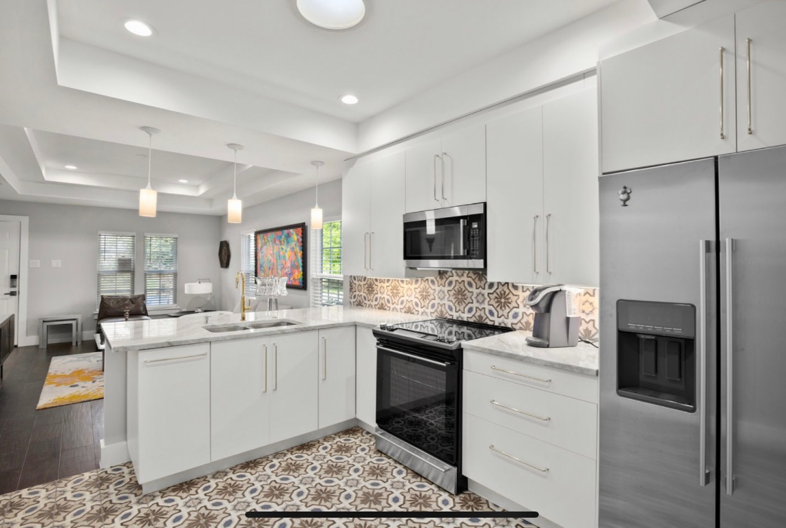 1305 Olander Street Austin, TX 78702 - Photo 8 of 14 a kitchen with a sink stove and refrigerator