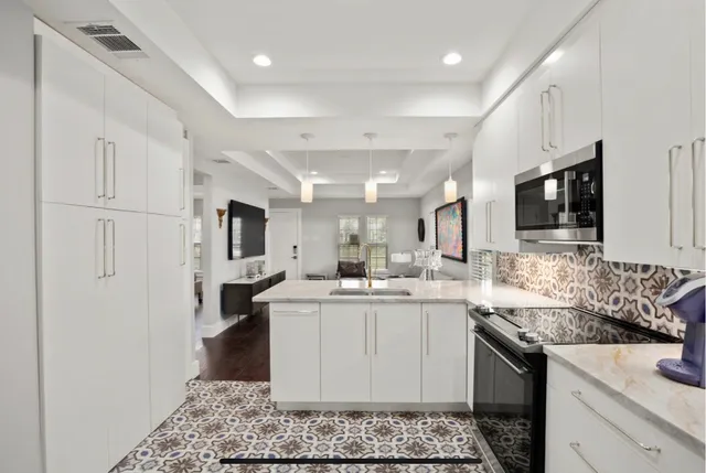 a kitchen with a sink stove and cabinets