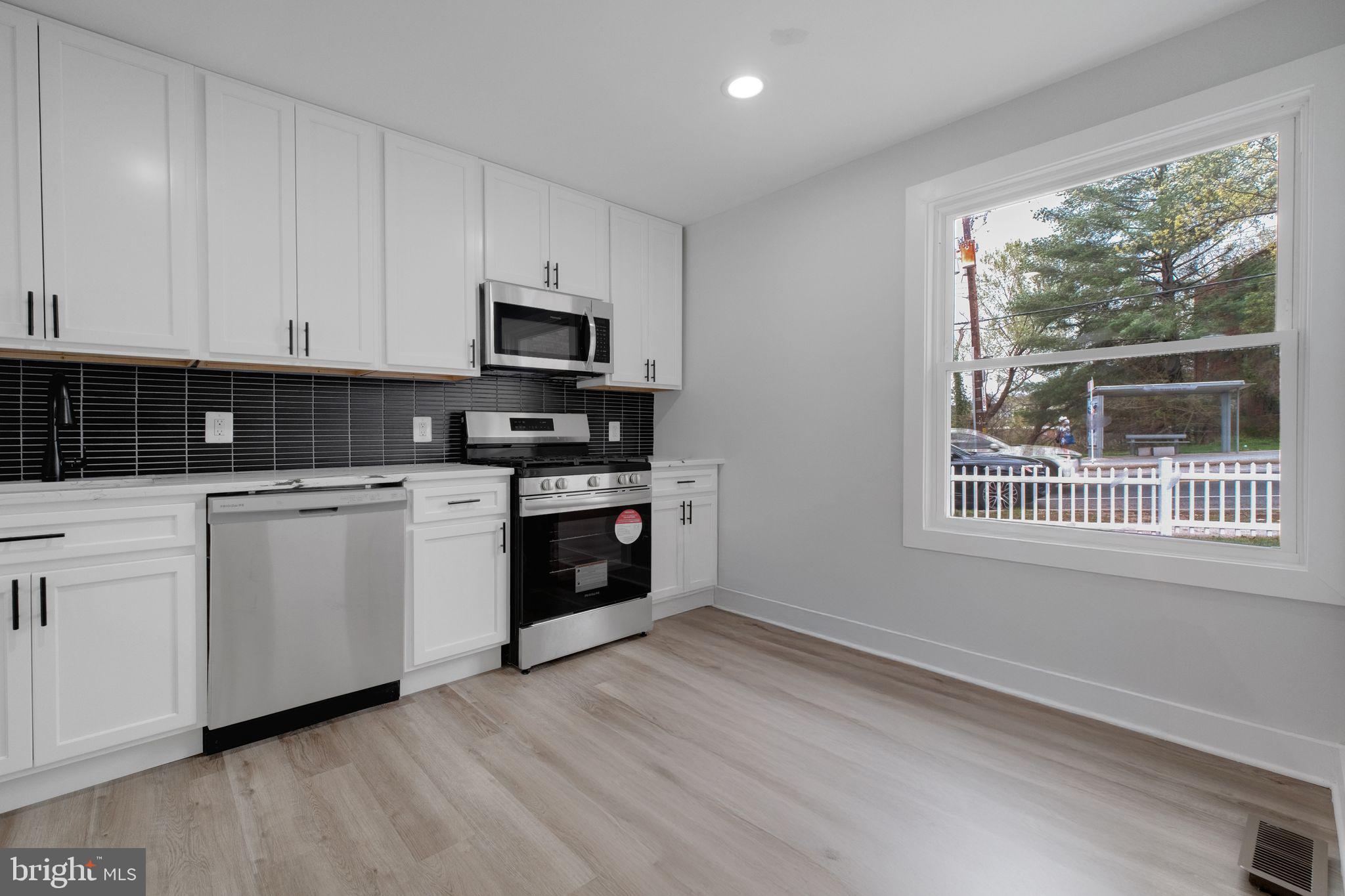 2503 Naylor Road Southeast Washington, DC 20020 - Photo 12 of 31 a kitchen with white cabinets a sink and a window