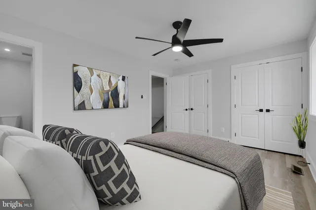 a bedroom with a bed and painting on the wall