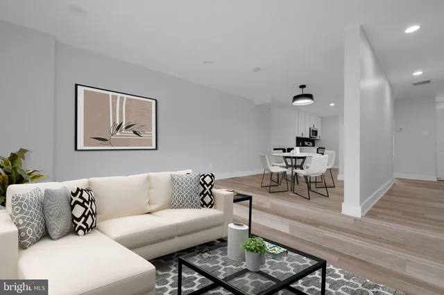 a living room with furniture and wooden floor