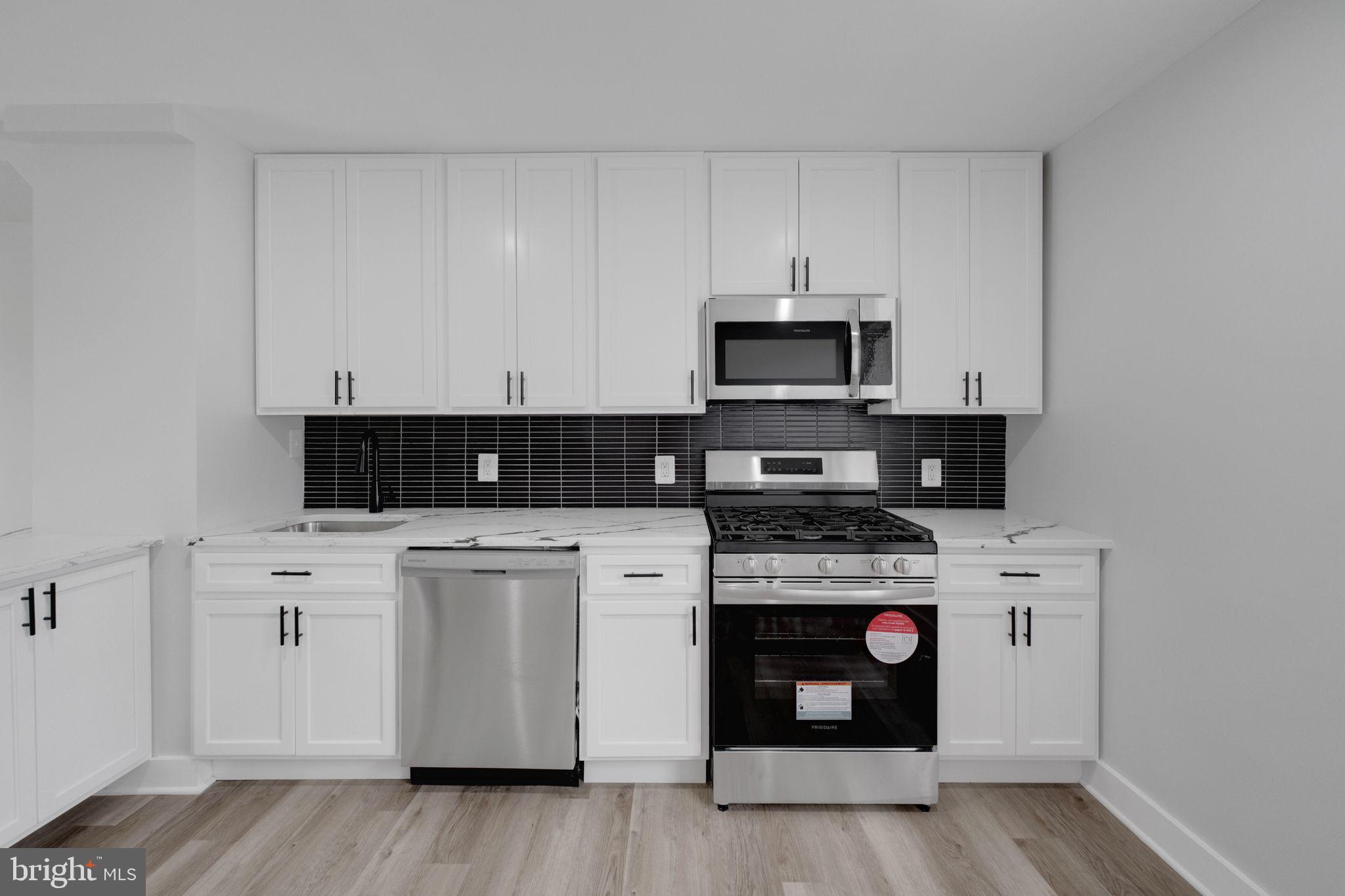 2503 Naylor Road Southeast Washington, DC 20020 - Photo 10 of 31 a kitchen with stainless steel appliances granite countertop a stove and white cabinets
