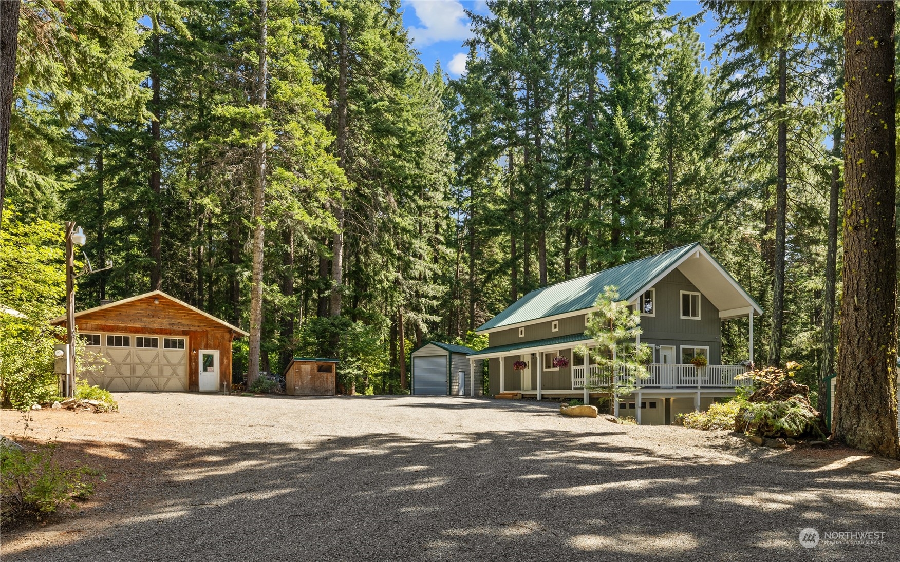 a front view of a house with a yard and large trees
