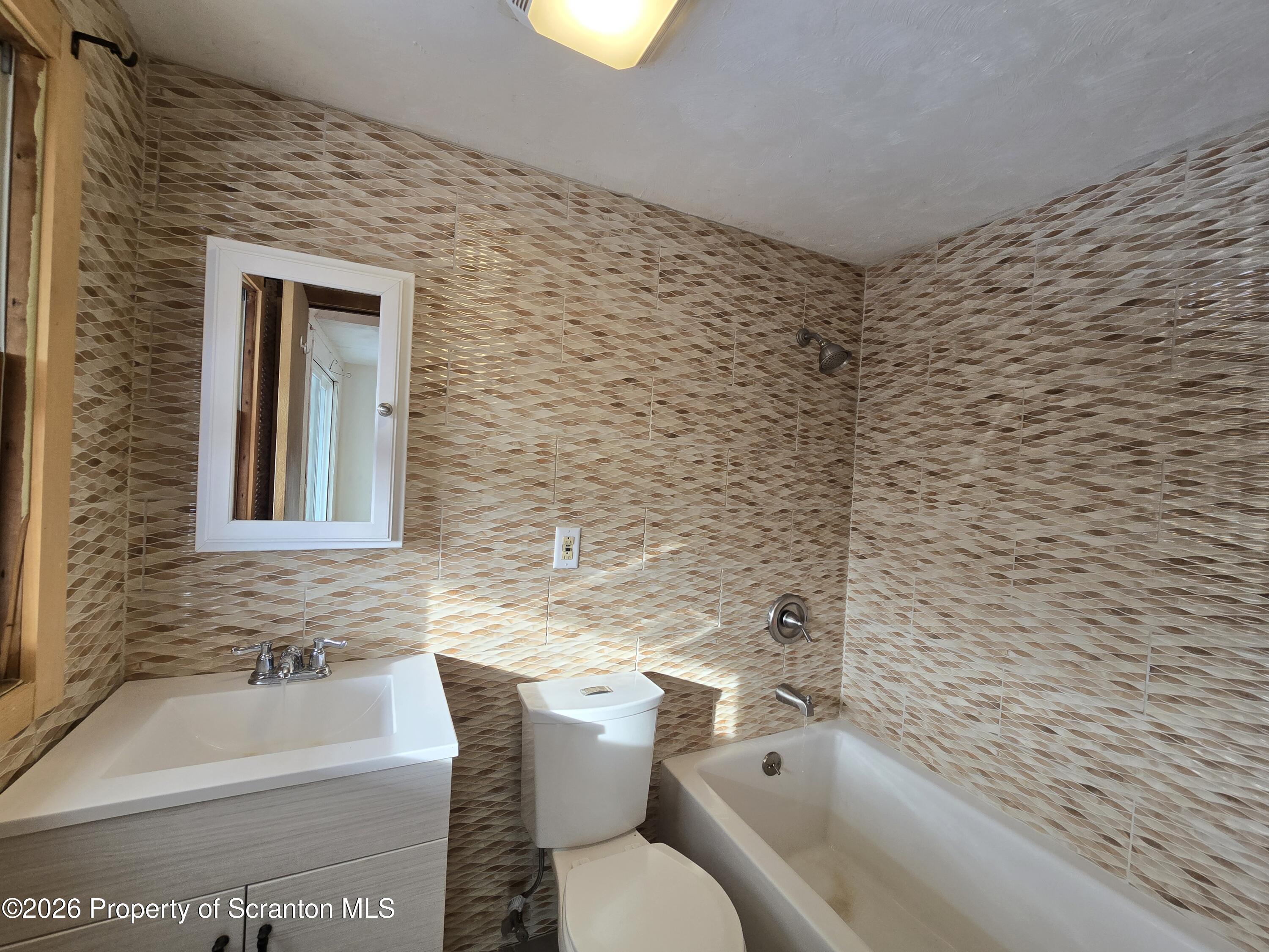 483 Turnpike Street Susquehanna, PA 18847 - Photo 20 of 27 a bathroom with a toilet a sink and bathtub