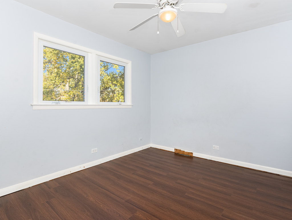 10548 Mason Avenue, Unit 2 Chicago Ridge, IL 60415 - Photo 11 of 13 an empty room with wooden floor and windows