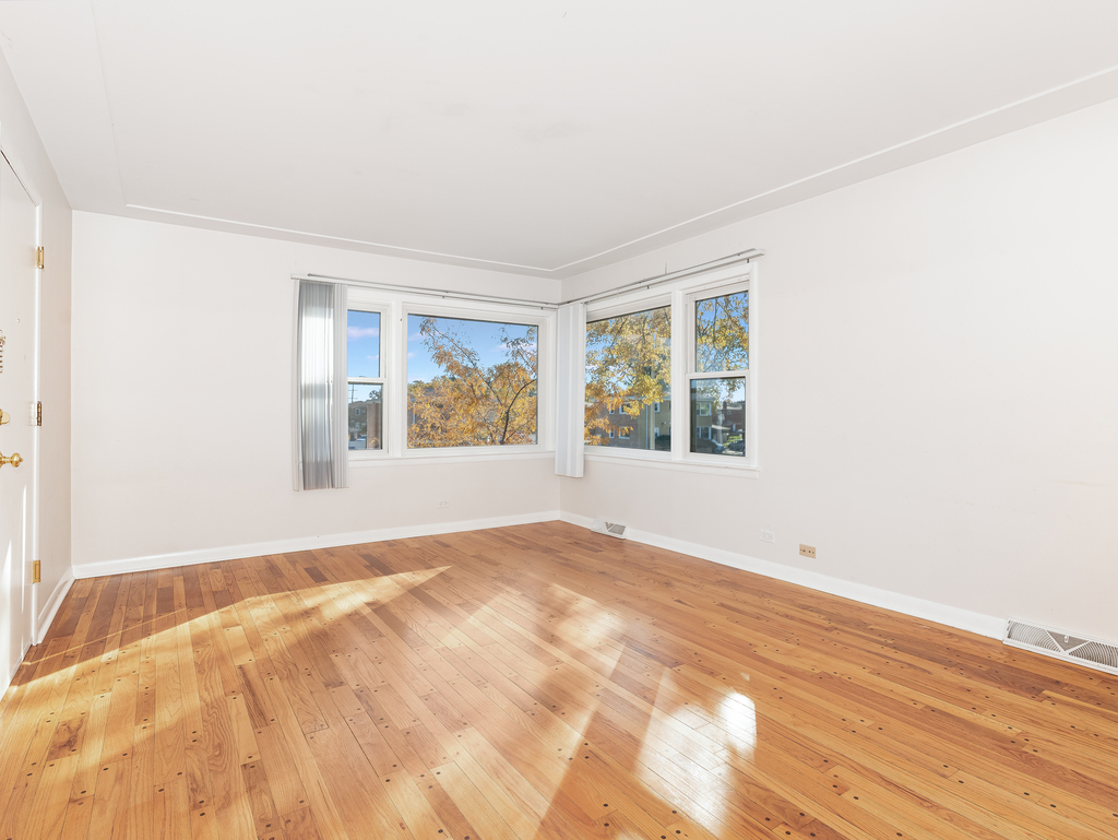 10548 Mason Avenue, Unit 2 Chicago Ridge, IL 60415 - Photo 2 of 13 a view of an empty room with a window