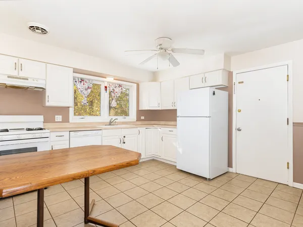 a kitchen with a refrigerator a sink and cabinets