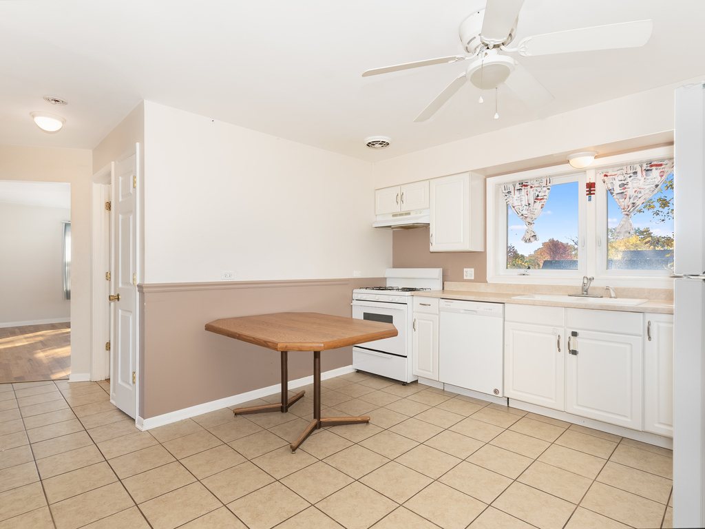 10548 Mason Avenue, Unit 2 Chicago Ridge, IL 60415 - Photo 9 of 13 a kitchen with a sink cabinets and wooden floor