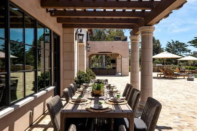 a view of a roof deck with table and chairs under an umbrella