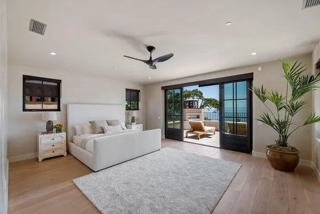 a bedroom with a bed and large window