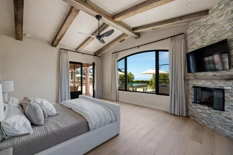 a living room with furniture and a floor to ceiling window