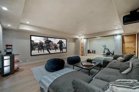 a living room with furniture large window and flat screen tv