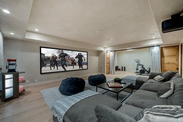 a living room with furniture large window and flat screen tv
