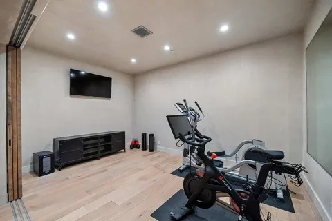 a view of pool with lawn chairs under an umbrella