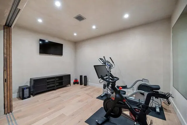 a view of pool with lawn chairs under an umbrella
