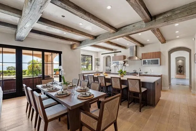 a view of a dining room with furniture and a potted plant