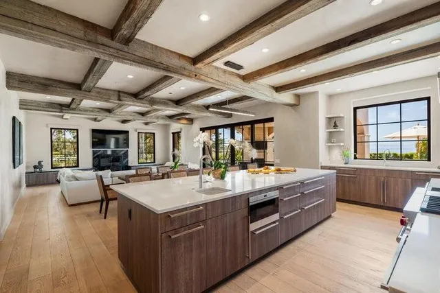 a living room with furniture wooden floor and a large window